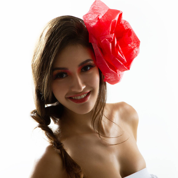 Vintage portrait of fashion glamour girl with red flower in her hair, over white. Studio shot. Spanish Carmen style - Fotoğraf, Görsel