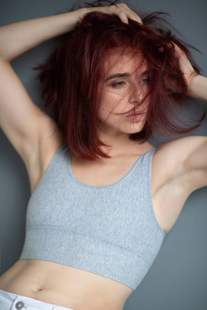 Beautiful young ginger woman with freckles. Fashion portrait of charming girl wearing casual clothes posing at home. Passion - 写真・画像