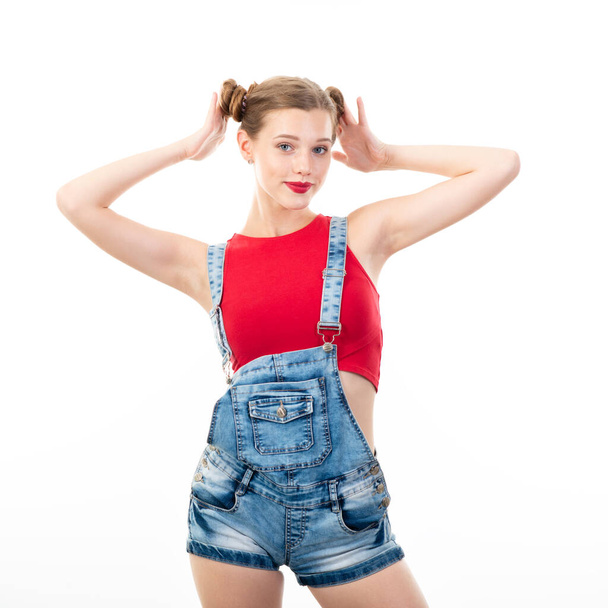Pretty teen girl, portrait over white background. Beautiful woman wearing red top and blue jeans. Young charming lady with blue eyes and blond hair - Φωτογραφία, εικόνα