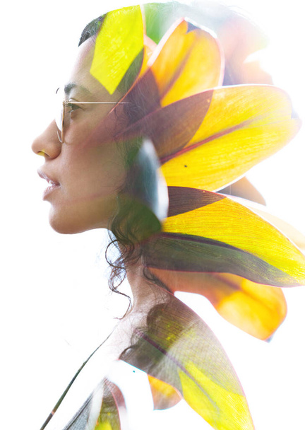 A double exposure portrait of a young woman profile with sun glasses against white background and tropical leaves - Valokuva, kuva