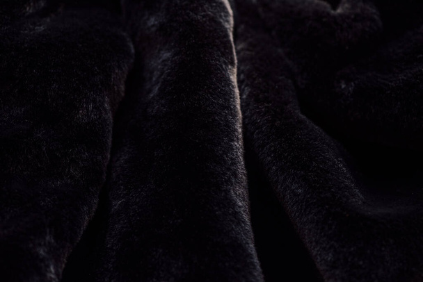 fluffy black fabric. Faux fur in black. Clothing item - Photo, Image