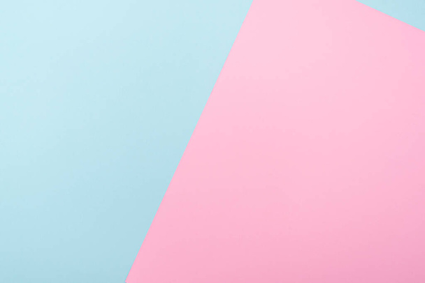 Composition with two color paper blue and pink, pastel tone, lay out with space for text - Фото, изображение