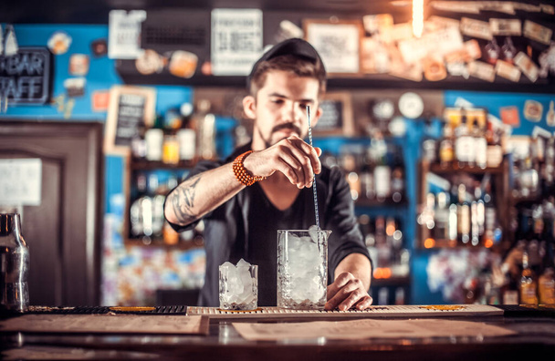 Bartender makes a cocktail in the beerhall - Photo, Image