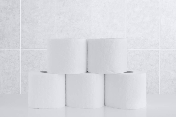 Rolls of toilet paper on a tile background. - Zdjęcie, obraz