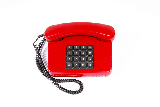 Piros vintage telefon gombokkal fehér szigetelt háttérrel. - Fotó, kép