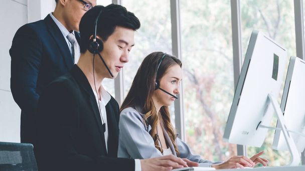 Business people wearing headset working in office - Foto, immagini