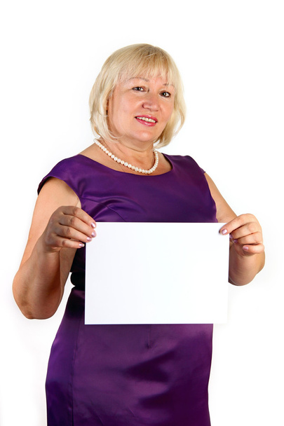 Elegant middle-aged woman holding white sheet of paper - Zdjęcie, obraz