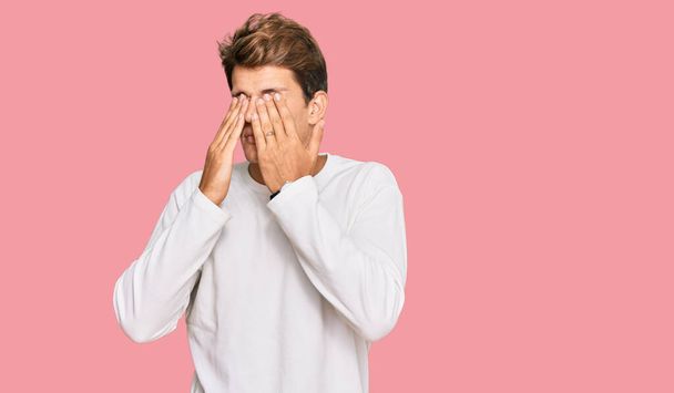 Handsome caucasian man wearing casual white sweater rubbing eyes for fatigue and headache, sleepy and tired expression. vision problem  - Photo, Image
