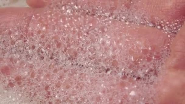 Foam on hand macro shot. Close-up bubbles on the palm and fingers. Selective focus - Footage, Video
