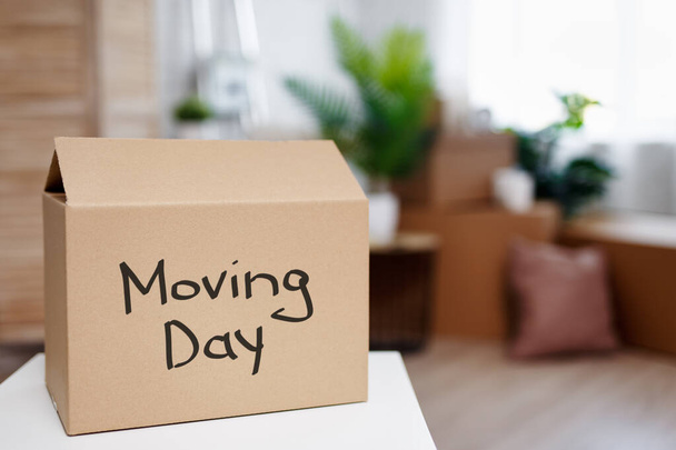 moving day and relocation concept - cardboard boxes in new house after moving day - Fotoğraf, Görsel