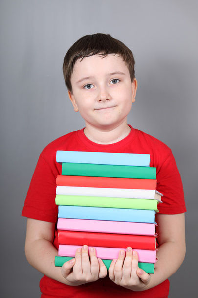 Boy with a pile of books - Photo, Image