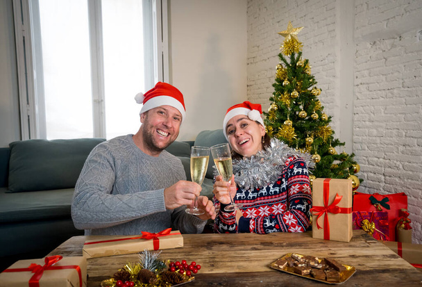 Happy couple celebrating Virtual christmas and new year in lockdown. Webcam view portrait of couple on video call or virtual christmas party. Online celebrations and COVID-19 social distancing. - Фото, зображення