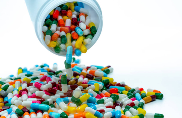 Pouring antibiotic capsule out of plastic bottle. Antibiotic drug resistance concept. Antibiotic drug overuse and smart use concept. Pharmaceutical industry. Pharmacy product. Prescription drugs. - Foto, Imagem