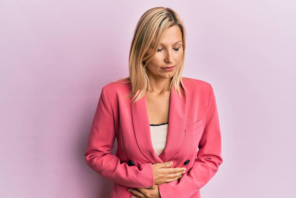 Middle age caucasian woman wearing business jacket with hand on stomach because indigestion, painful illness feeling unwell. ache concept.  - Φωτογραφία, εικόνα