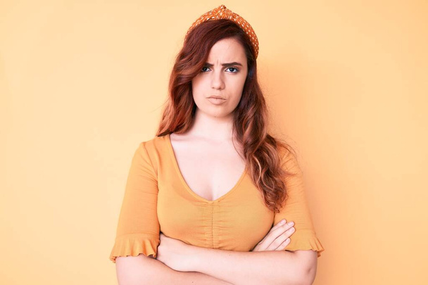 Young beautiful woman wearing casual clothes skeptic and nervous, disapproving expression on face with crossed arms. negative person.  - Photo, Image