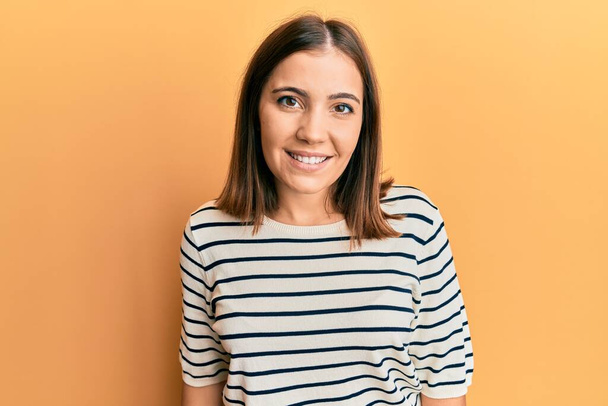 Young caucasian woman wearing casual striped shirt smiling with an idea or question pointing finger up with happy face, number one  - Photo, Image