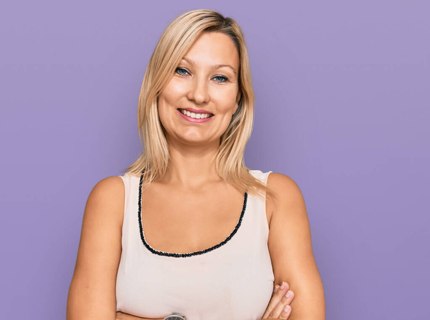 Middle age caucasian woman wearing casual clothes happy face smiling with crossed arms looking at the camera. positive person.  - Photo, Image
