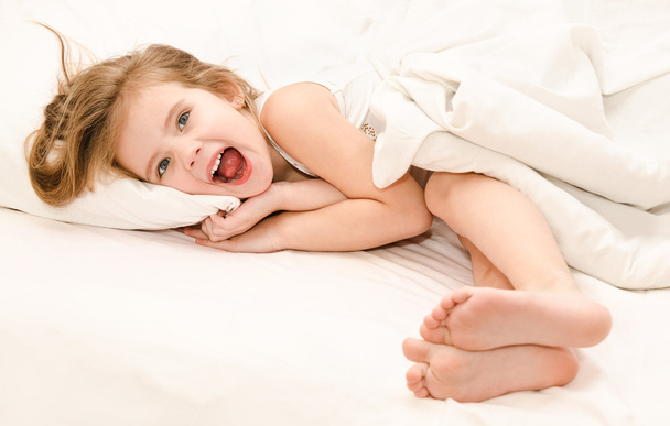 Adorable little girl waked up in her bed  - Fotografie, Obrázek