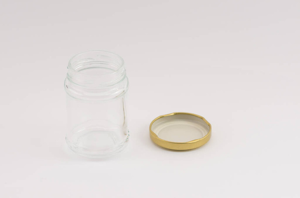A high angle shot of an empty glass jar isolated on a white background - Zdjęcie, obraz