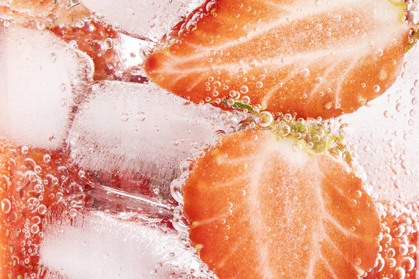 A closeup shot of strawberries and ice cubes - Photo, Image