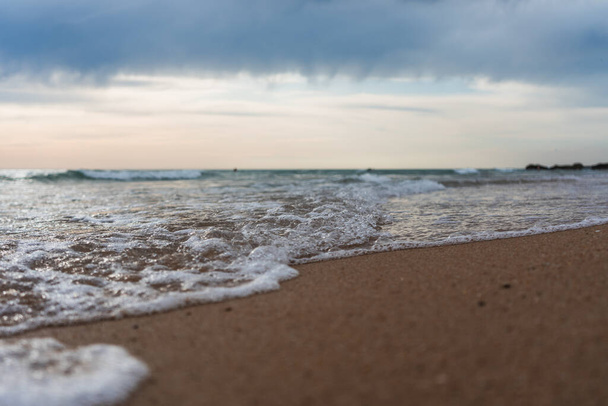 A beautiful shot of waves on a sandy beach - Photo, image