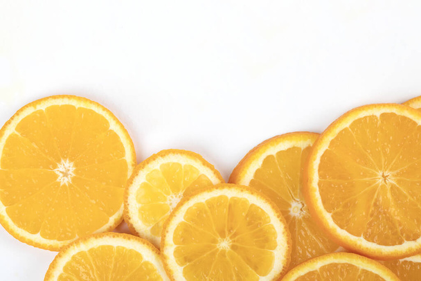 A closeup shot of slices of orange on a white background - Fotografie, Obrázek