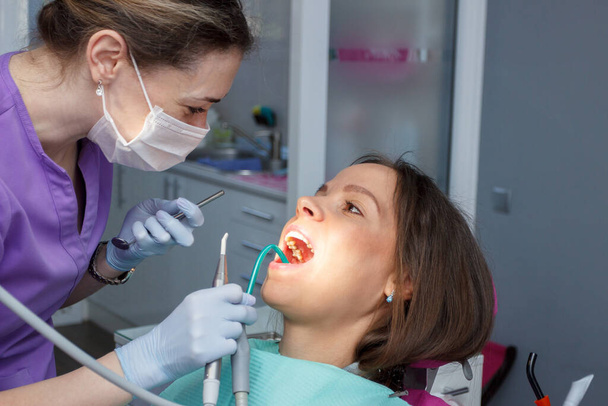 Examination oral cavity or treatment teeth, visiting dental office, soft focus background - Foto, afbeelding