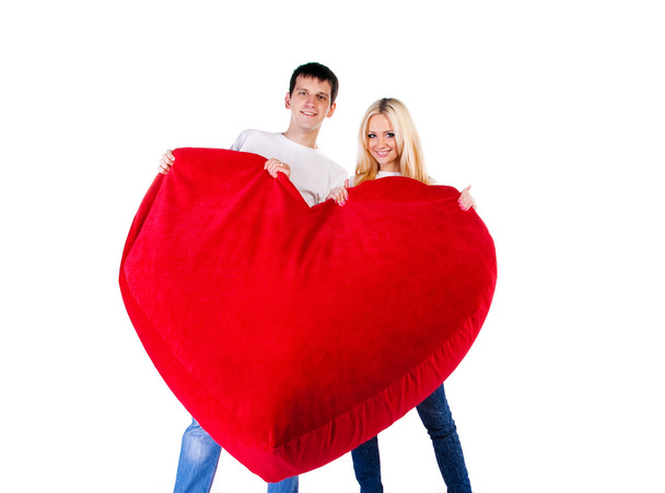 Young couple with a big heart on white - Фото, зображення