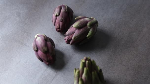 Fresh Italian artichokes on gray background, seen from above, free area for editions - Footage, Video