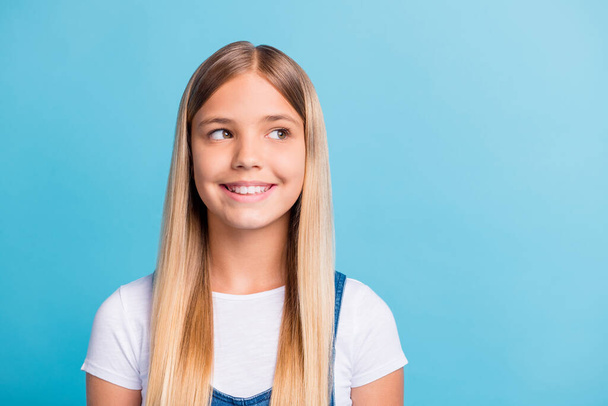 Photo portrait of dreamy girl looking at blank space isolated on pastel blue colored background - Foto, immagini