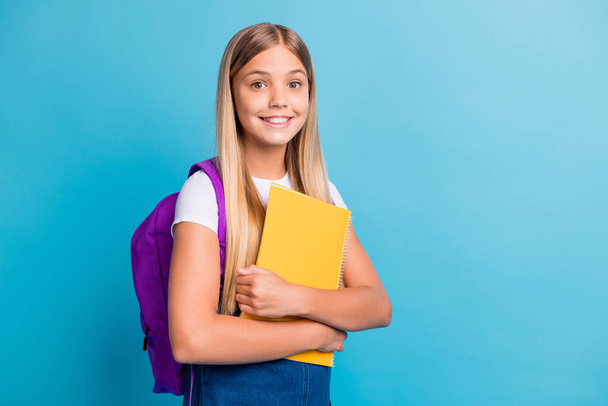 Photo of cool nice teen girl go to school take book bag wear denim dress isolated on pastel blue color background - Φωτογραφία, εικόνα