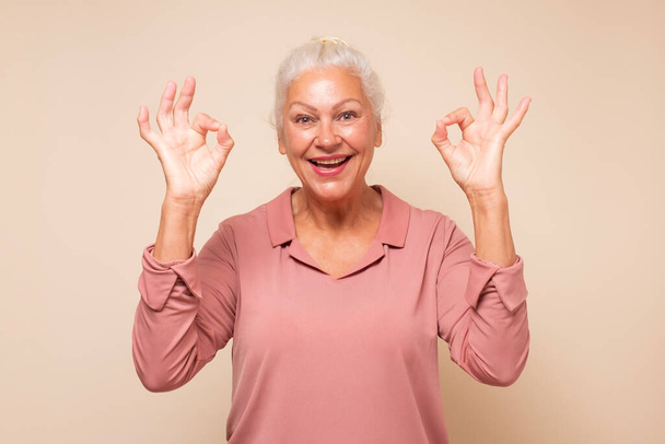 Senior woman doing ok gesture with hand smiling approving your choice. - Φωτογραφία, εικόνα