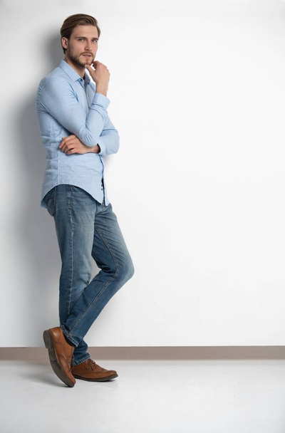 Full length studio portrait of casual young man in jeans and shirt. Isolated on white background. - Foto, Imagen