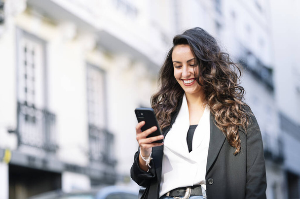 Beautiful woman using a mobile in the street. Communication concept - Photo, Image