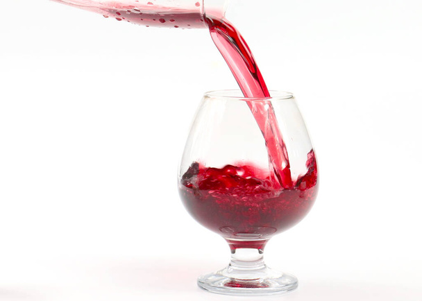 red wine pours into the glass creating whimsical swirls - Foto, Imagem