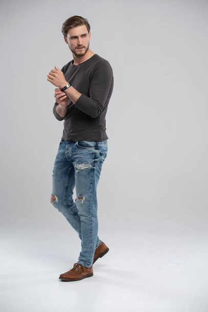 Full length studio portrait of casual young man in jeans and shirt. Isolated on white background. - Fotografie, Obrázek