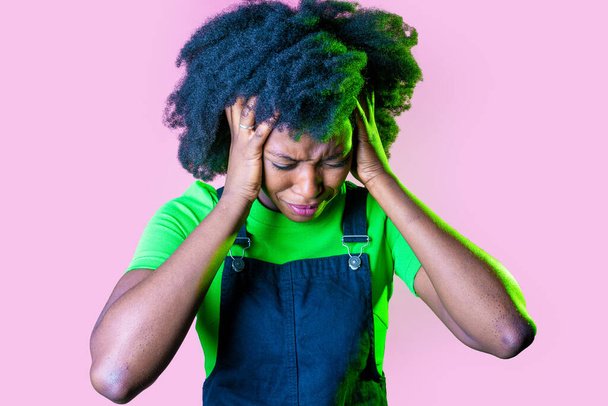 Young black woman on pink background suffering headache - Afro american female isolated suffering violence - stop racism, pain, racism concept - Fotó, kép