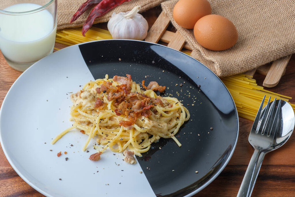 Spaghetti Carbonara,Carbonara pasta, hard parmesan cheese and cr - 写真・画像