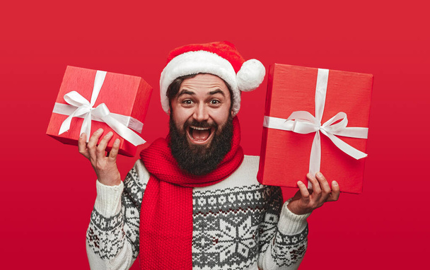 Delighted bearded man showing Christmas presents - Zdjęcie, obraz