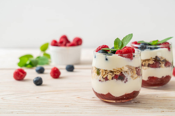 homemade raspberry and blueberry with yogurt and granola - healthy food style - Photo, image