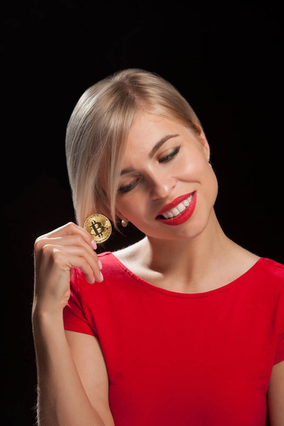 Woman holding physical bitcoin cryptocurrency coins in her hands - 写真・画像