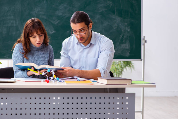 Young female student and male teacher in the classroom - Photo, Image