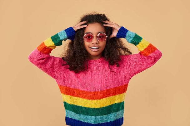 Excited hipster girl in colorful sweater and sunglasses - Fotografie, Obrázek