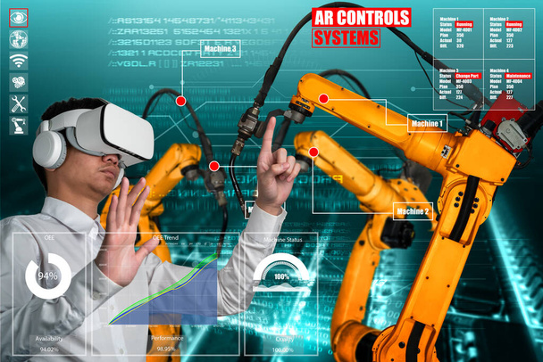 Ingeniero controla brazos robóticos mediante tecnología de la industria de realidad aumentada - Foto, Imagen