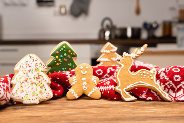 winter gingerbread cookies and scarf on wooden background - Photo, Image