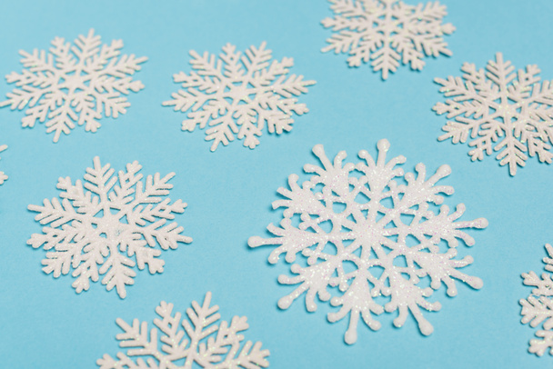 top view of winter snowflakes on blue background - Valokuva, kuva
