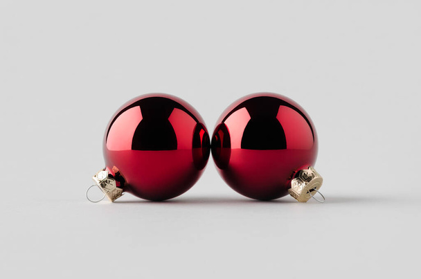 Two red glossy Christmas balls mockup on a seamless grey background. - Foto, imagen