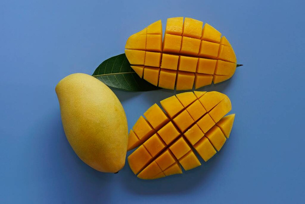 рубленые манго на синем фоне - Фото, изображение