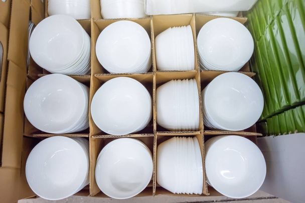 New deep white plates for liquid food in boxes for sale - Photo, Image
