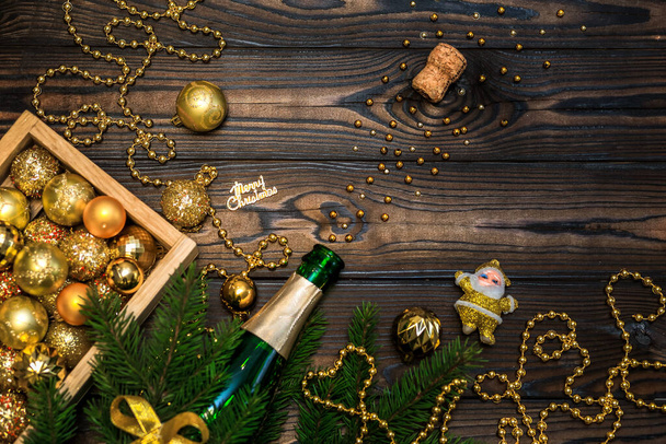 Christmas flat lay, champagne, fir branches and decorations on a wooden background, decorative Christmas composition - Foto, afbeelding